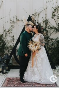 Outdoor wedding ceremony photo at The Edison Barn. Wedding ceremony kiss.